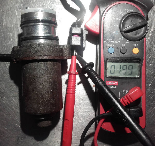 Generation 4 Haldex pump being tested for resistance with a multimeter using the ohms setting